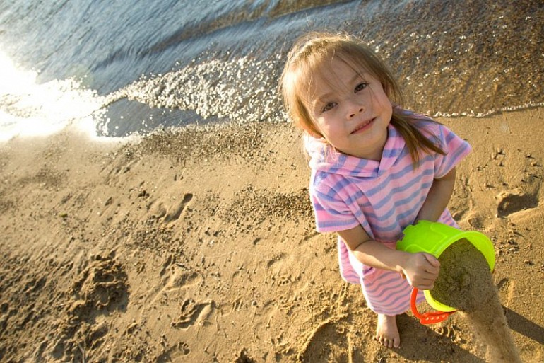 51_6 little girl on beach with bucket resized Beach Fun Gallery Image